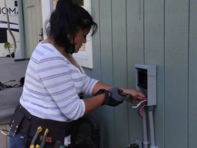 Licensed electrician wiring an exterior subpanel in Huron
